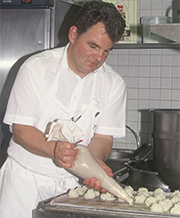 Jean-Marc Muller - Arranging coconut macarons on a baking sheet